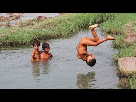 Village boy swimming in water